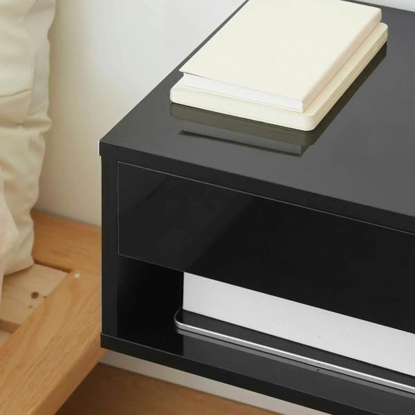 High-gloss black floating bedside table detail with open shelf and drawer space