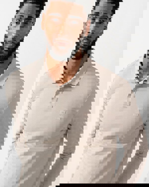 detail shot of a model wearing a BOSS Orange Passerby Mens Long Sleeve Stretch-Cotton Polo Shirt with Logo Patch in Open Grey