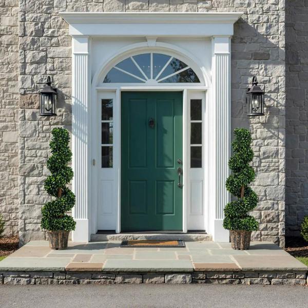 Set of 2 potted artificial spiral plants with dense green leaves beside a doorway