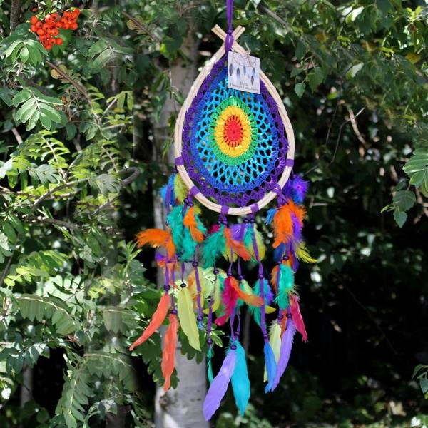 Teardrop dream catcher with blue net, rainbow feather fringe, and multicolor center flower.