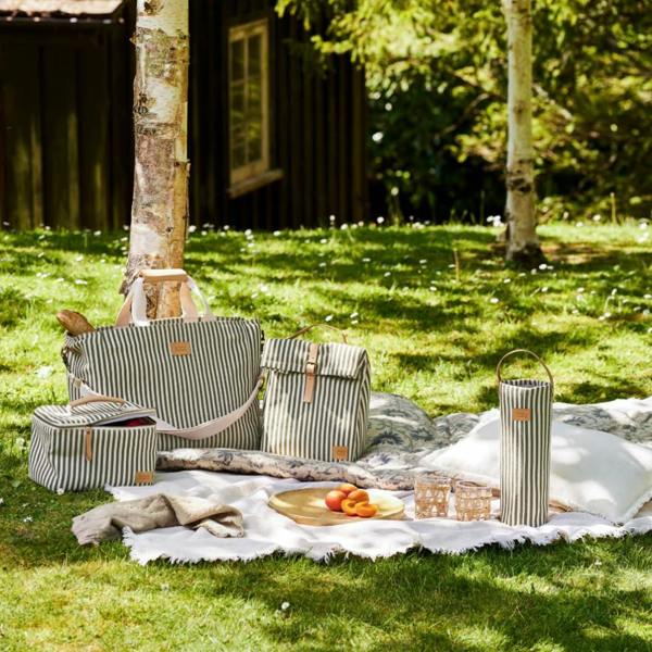The full Hove picnic collection, including the square lunch bag, displayed in a garden.