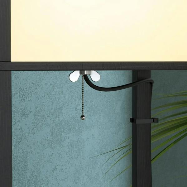 Close-up of black column lamp top with glowing shade and pull-chain detail