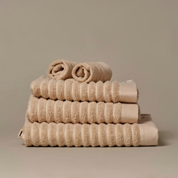 Organic cotton beige bathroom towels. Super soft ribbed towels in four sizes: hand towel, bath towel, bath sheet and face cloths. 