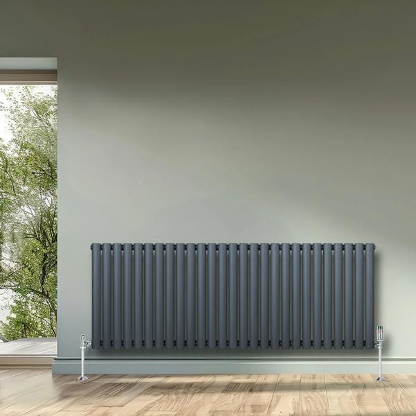 Oval single column radiator in anthracite grey, 600mm x 1620mm, featuring vertical fins and sleek design, installed on a light wall
