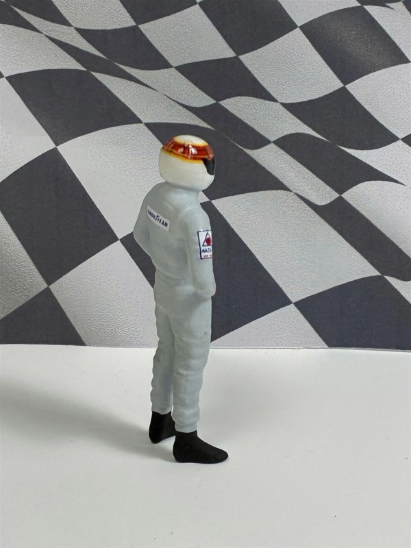 a toy astronaut in front of a checkered flag