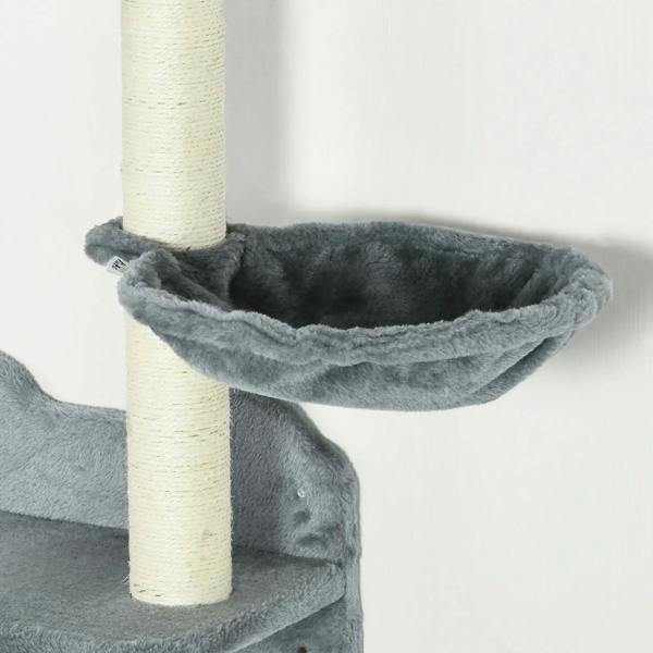 Grey fabric hammock perch on a wall-mounted cat tree with a vertical scratching post