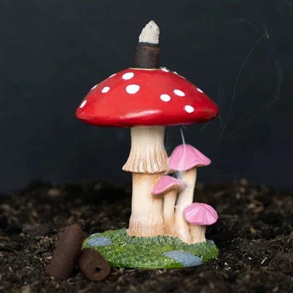 Mushroom backflow incense burner with red white-dotted cap, pink accents, and green base