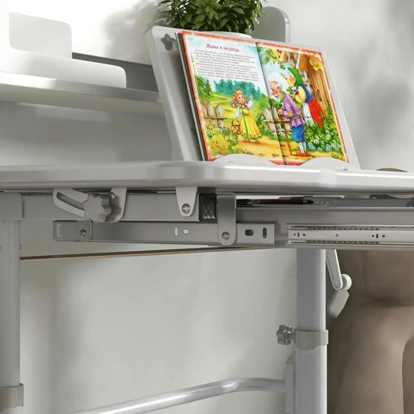Grey open storage area under adjustable kids desk tabletop