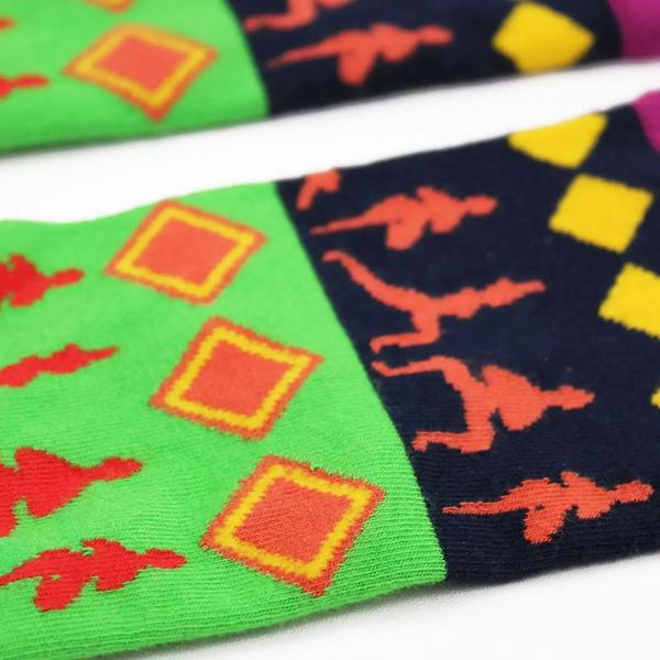 Close-up of multicolor bamboo sock knit with yoga silhouettes and diamonds