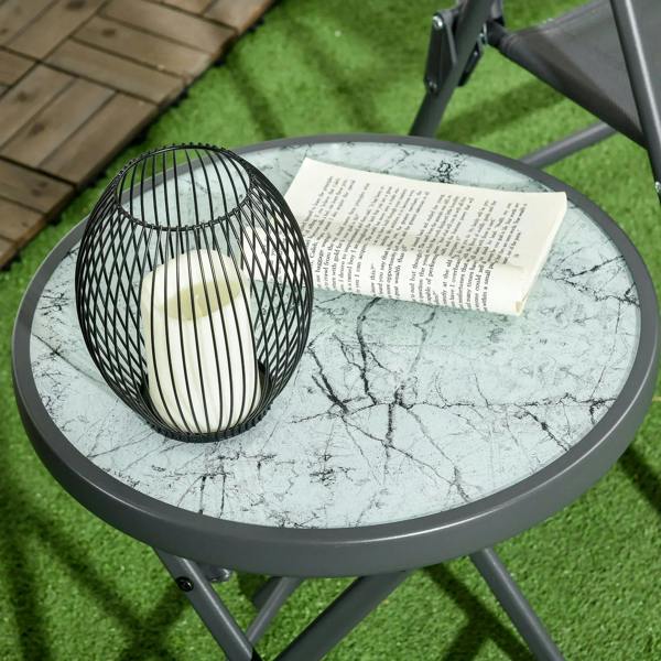 Round folding outdoor side table with marble-look glass top and dark gray frame