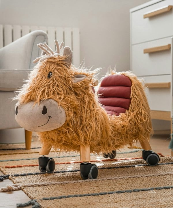 Hubert highland cow kids ride on toy in nursery room 
