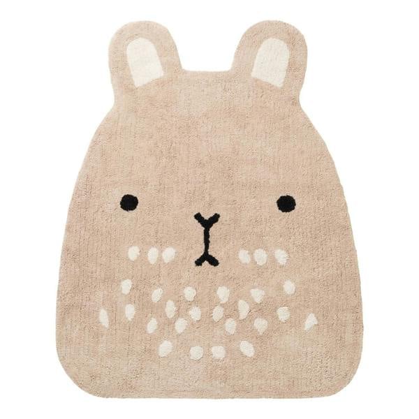 Beige animal-shaped rug with a face design on a white background