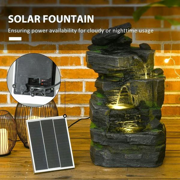 Solar powered dark grey rock fountain with warm white LED glow and moss accents