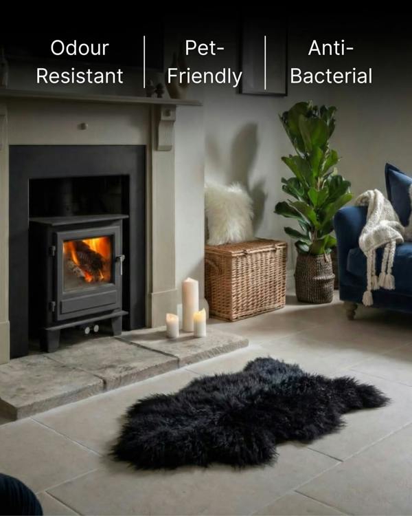 Black Mongolian Sheepskin Rug in front of fireplace