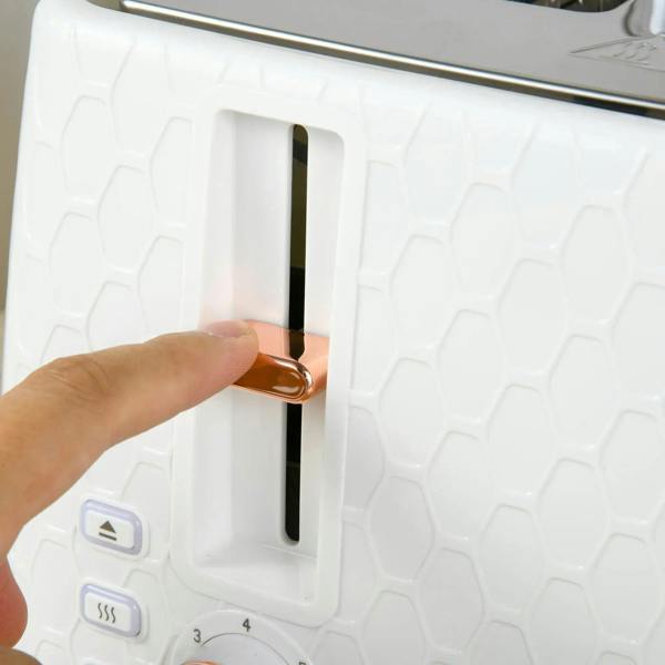 White electric kettle close-up of hand pressing the toaster-style heating lever