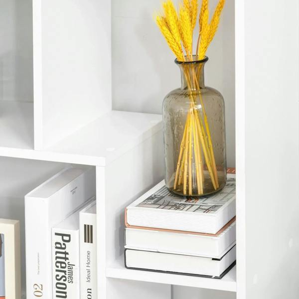 White 8-cube bookcase cubby with stacked books and yellow-stem vase on shelf.