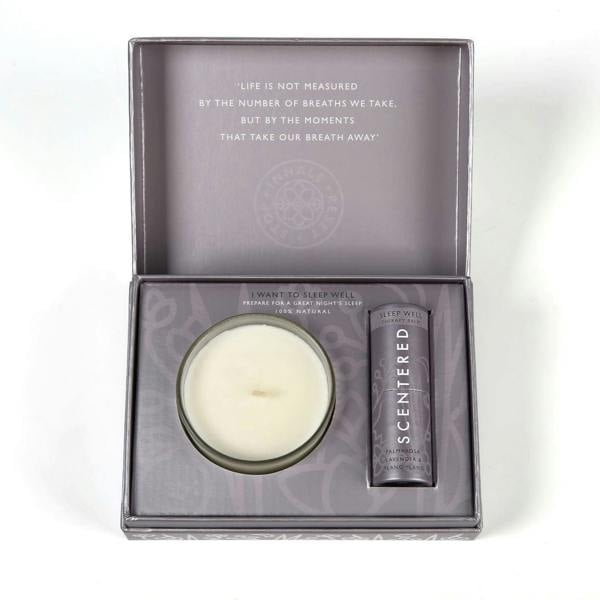 A sleep well balm and a candle packed in a gift box