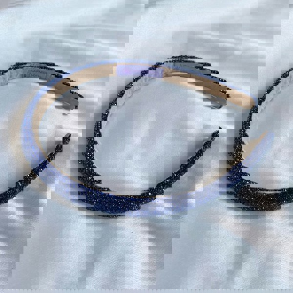 Navy blue hair band, slim design, sparkly crystal embellishments, shimmering finish, elegant decorative accessory
