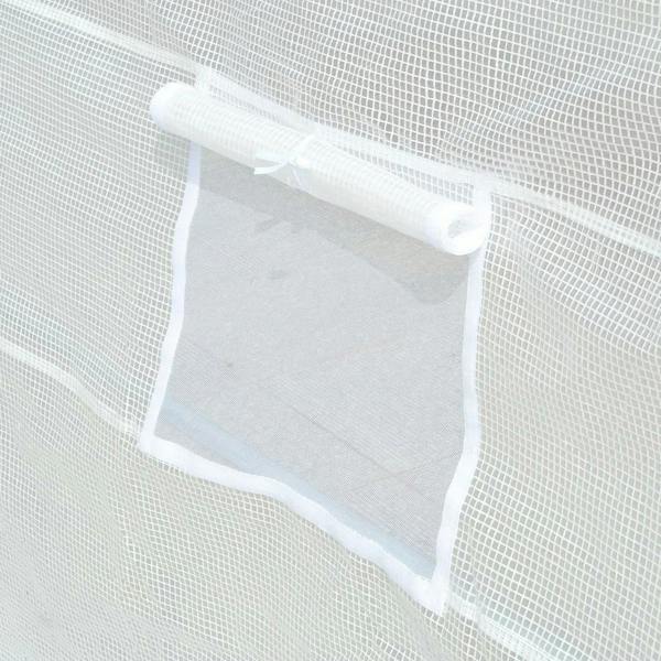 Roll-up window panel detail on a white mesh greenhouse cover
