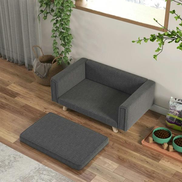 Grey dog sofa bed with cushion and matching floor pad, corner view