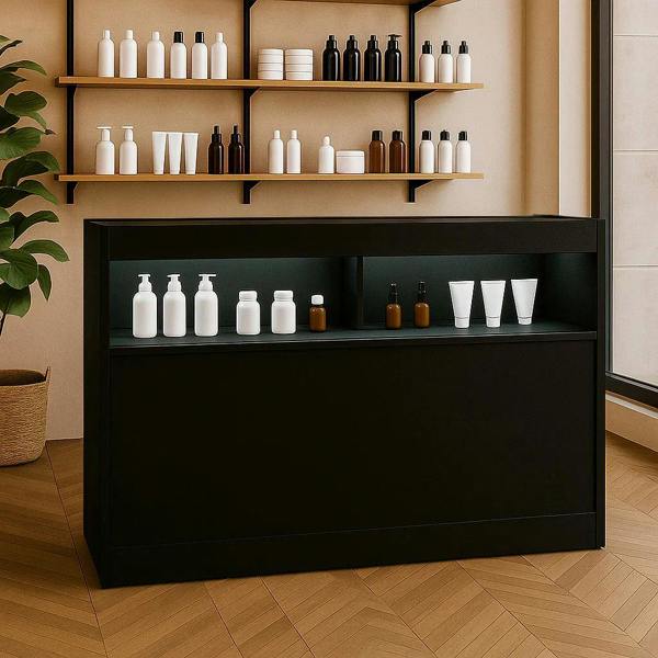 Sleek black LED retail shop counter B1500 with illuminated shelves, displaying various bottles against a modern interior backdrop
