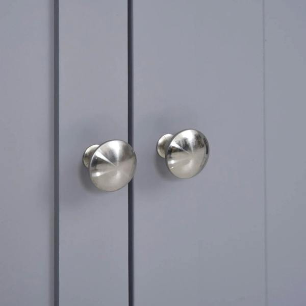 Close-up of two silver round cabinet door knobs on grey double doors