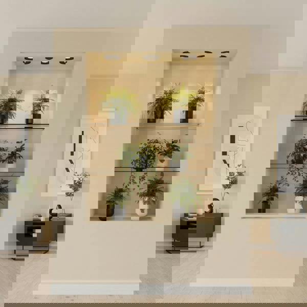 Mini recessed spot lamp above plants and shelves on a pale yellow background