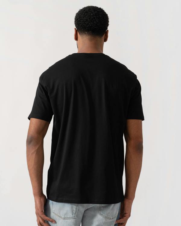 Model wearing Armani Exchange Mens A|X Monogram T-Shirt in Black UC001 - back