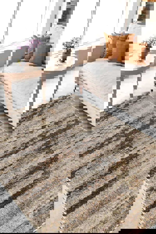 Aspre Shades Lines Rug with brown stripes on a living room floor, enhancing sophisticated decor and comfort.