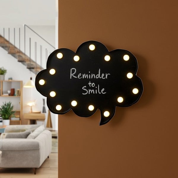 Decorative wall light shaped like a cloud with 'Reminder to Smile' text in a living room.