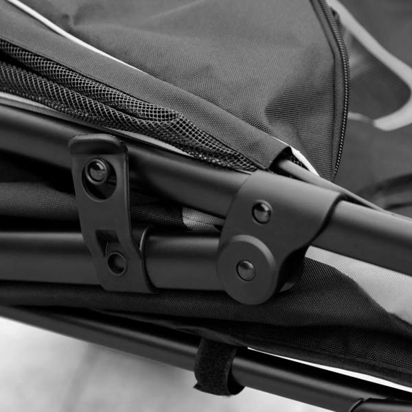 Black pet stroller frame joint and fabric strap attachment close-up