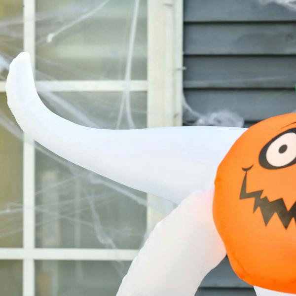 Close-up of orange jack-o-lantern head on a white inflatable ghost