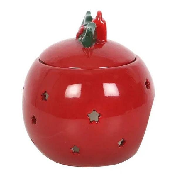 Red bauble oil burner with green holly top and decorative star cutouts.