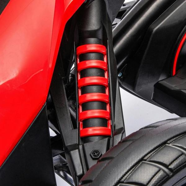 Red coil spring suspension detail on red kids electric go-kart, close-up