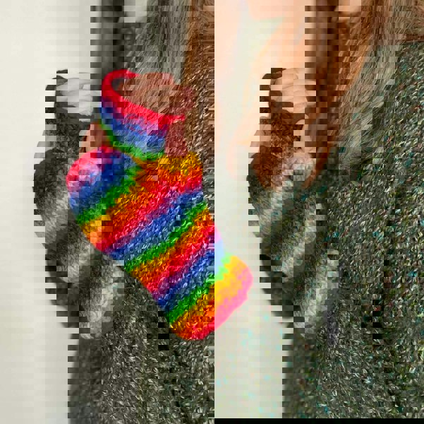 A woman wearing Woollen Rainbow Handwarmer Gloves.