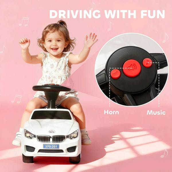 White ride-on car with black steering panel showing horn and music buttons
