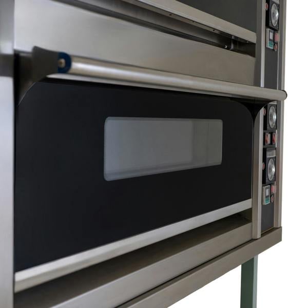 Large commercial pizza oven with stainless steel finish, dual baking chambers, and control knobs for precise temperature settings