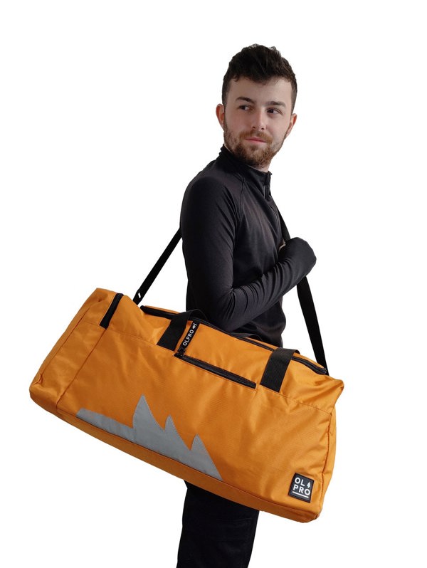 Orange 40L Holdall OLPRO man carrying bag on shoulder