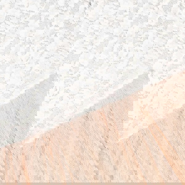 Close-up of apricot champagne fabric with a textured pattern on a white lace background