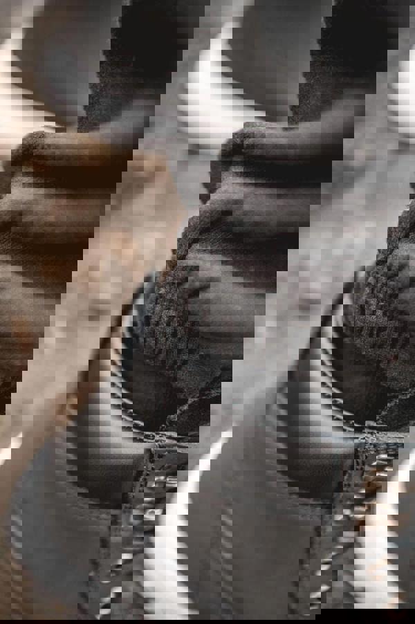 WorkTough Mens Cargo Stretch Fit Cordura Work Trouser Fleece Jogger, close-up image showing durable black work boot, elastic waistband, and black fleece jogger pants.