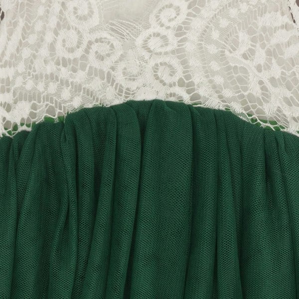 Green fabric with white lace trim on a neutral background