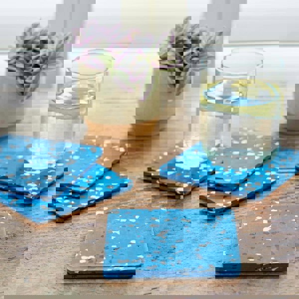 Blue plastic coasters on a wooden table.