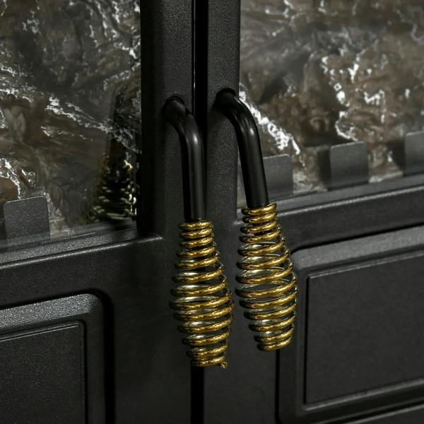 Close-up of gold spring handles on a black electric fireplace stove heater door
