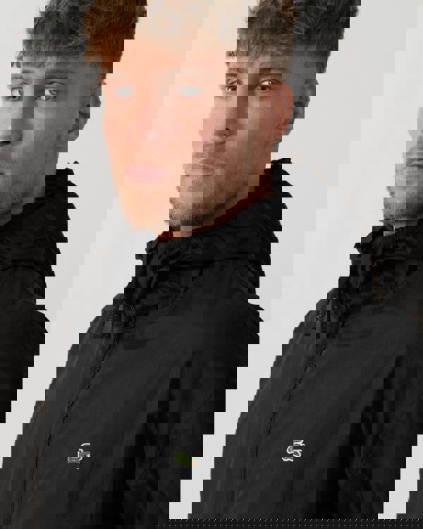 Model wearing Lacoste Lightweight Packable Water-Repellent Ripstop Jacket in Black 031 - Detail