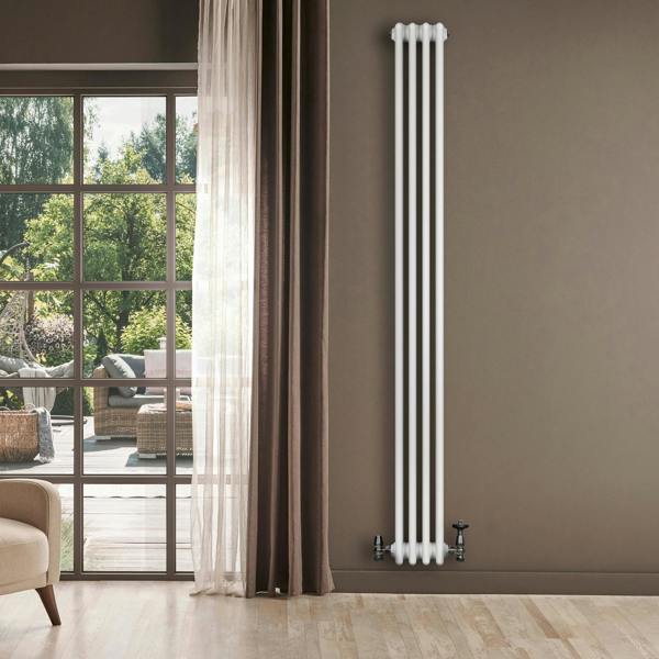 Traditional white 4 column radiator with valves, standing tall against a neutral wall, enhancing a bright, modern living space