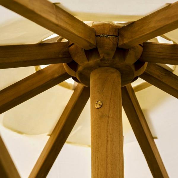 An under-canopy view looking directly up at the fixed wooden top notch hub and sprawling timber ribs of an open teak parasol.