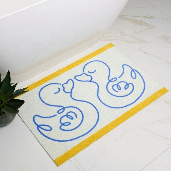 Bath mat with duck design on a bathroom floor