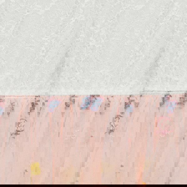 Close-up of a pink fabric with floral patterns on a textured white background