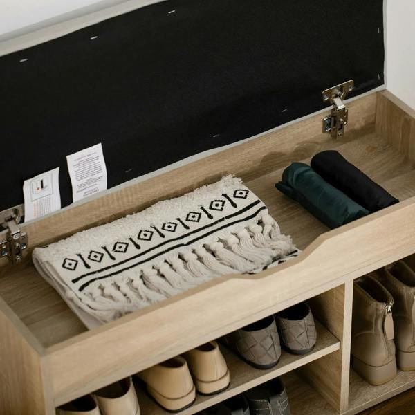 Oak-tone shoe cabinet bench with open lid and front shelf for shoes and folded textiles