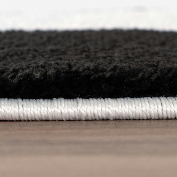 Close-up of black and white textured materials on a wooden surface